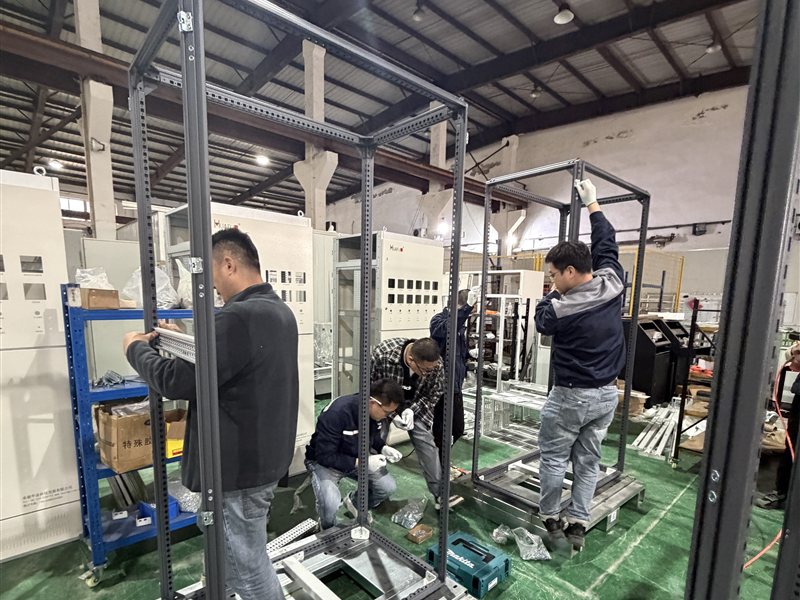 LANSGRID workshop team assembling a modular electrical cabinet frame